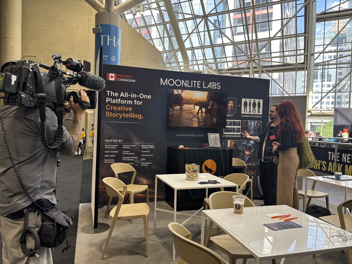 A television camera operator filming at the Moonlite Labs booth